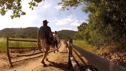 Aj and Lindsey hiking by fence
